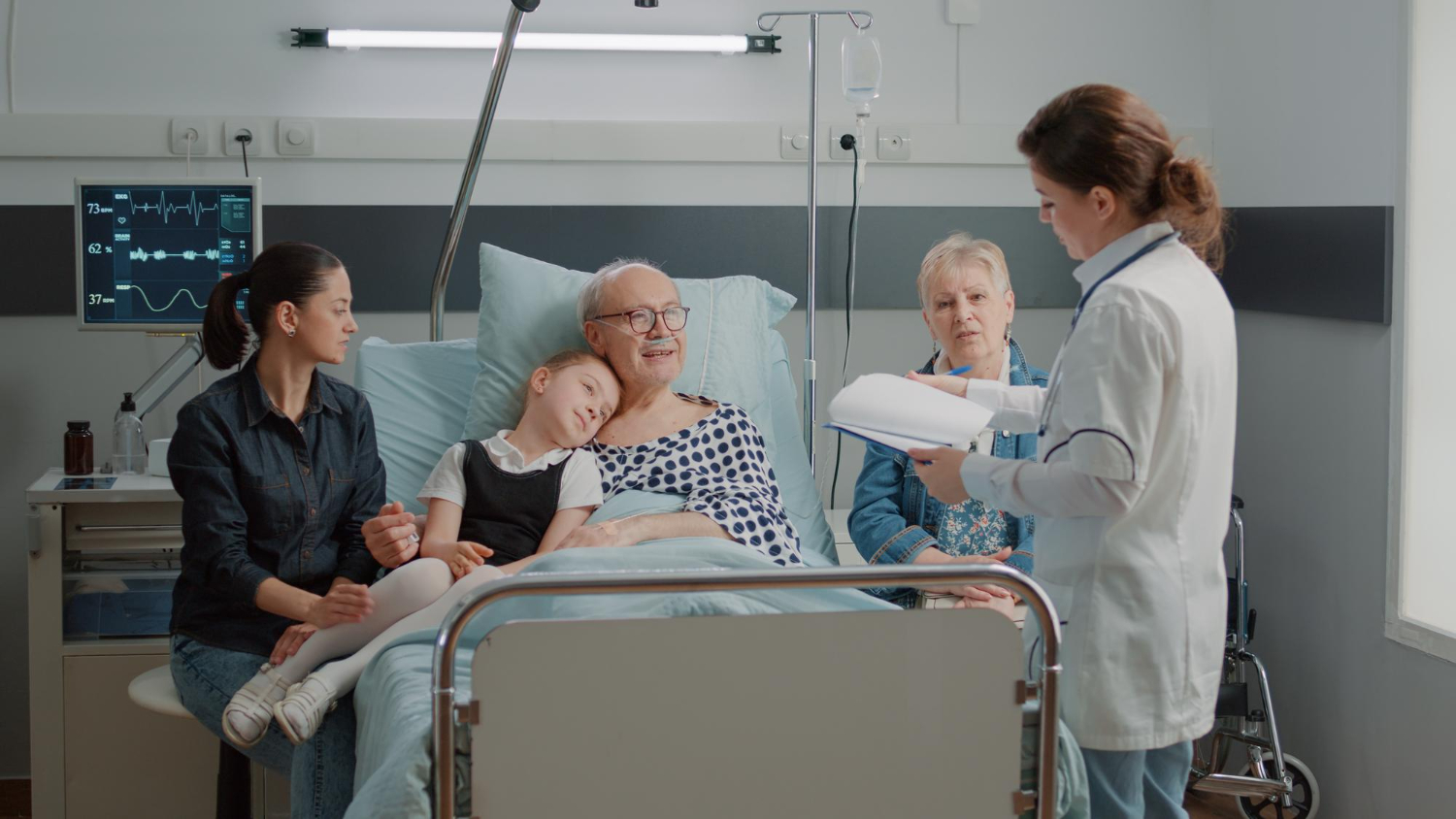 A relative sitting with a patient in a bright hospital room