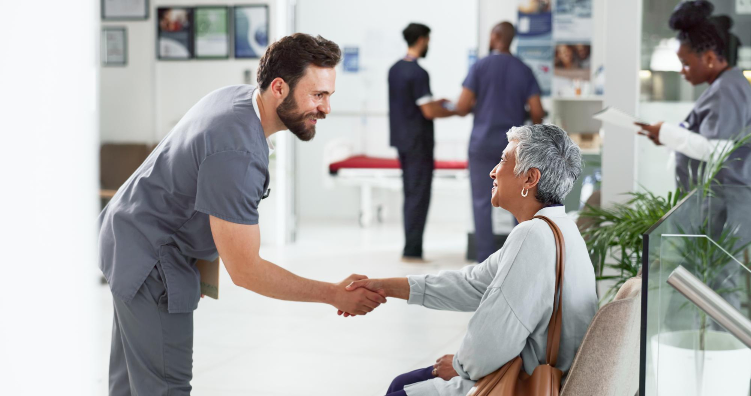Nurse welcoming patient and their relative at the reception 